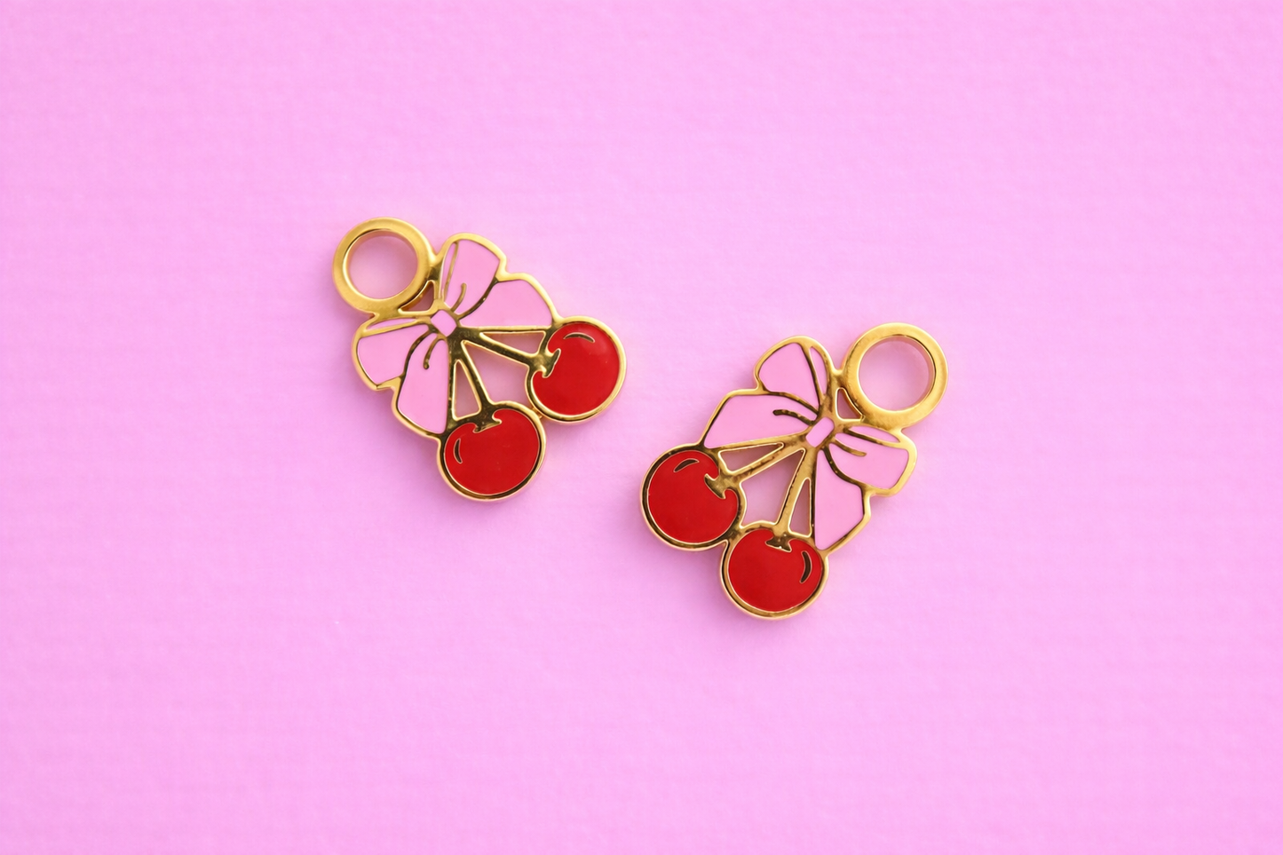 bow cherry charms on pink background