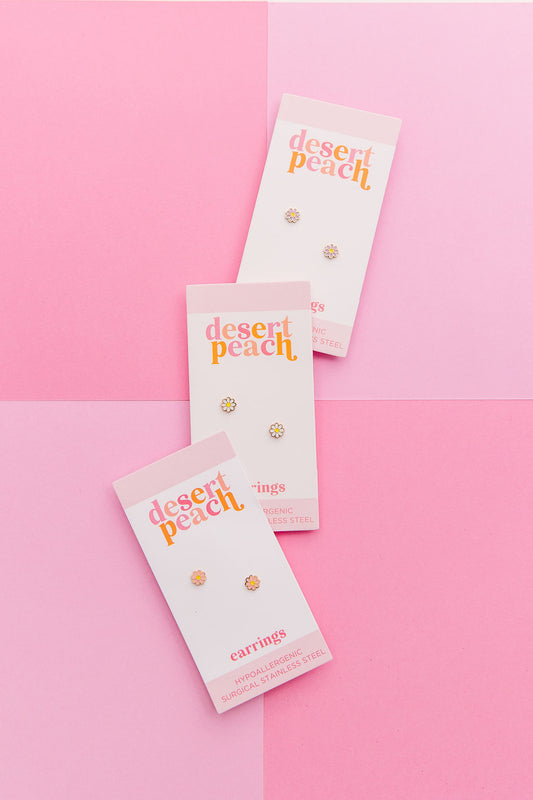 Pink, lavender and white daisy stud earrings shown together