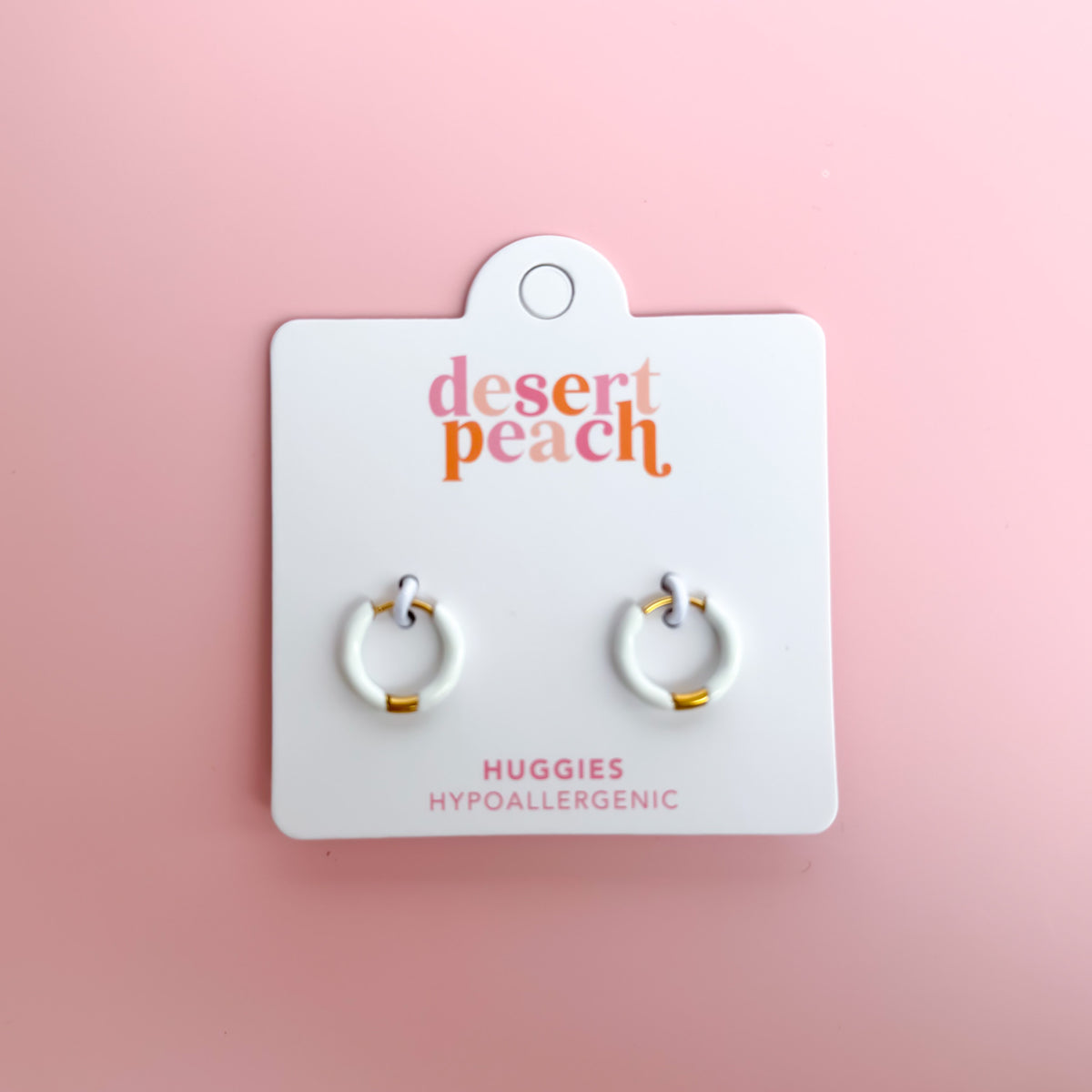 White huggie hoop earrings