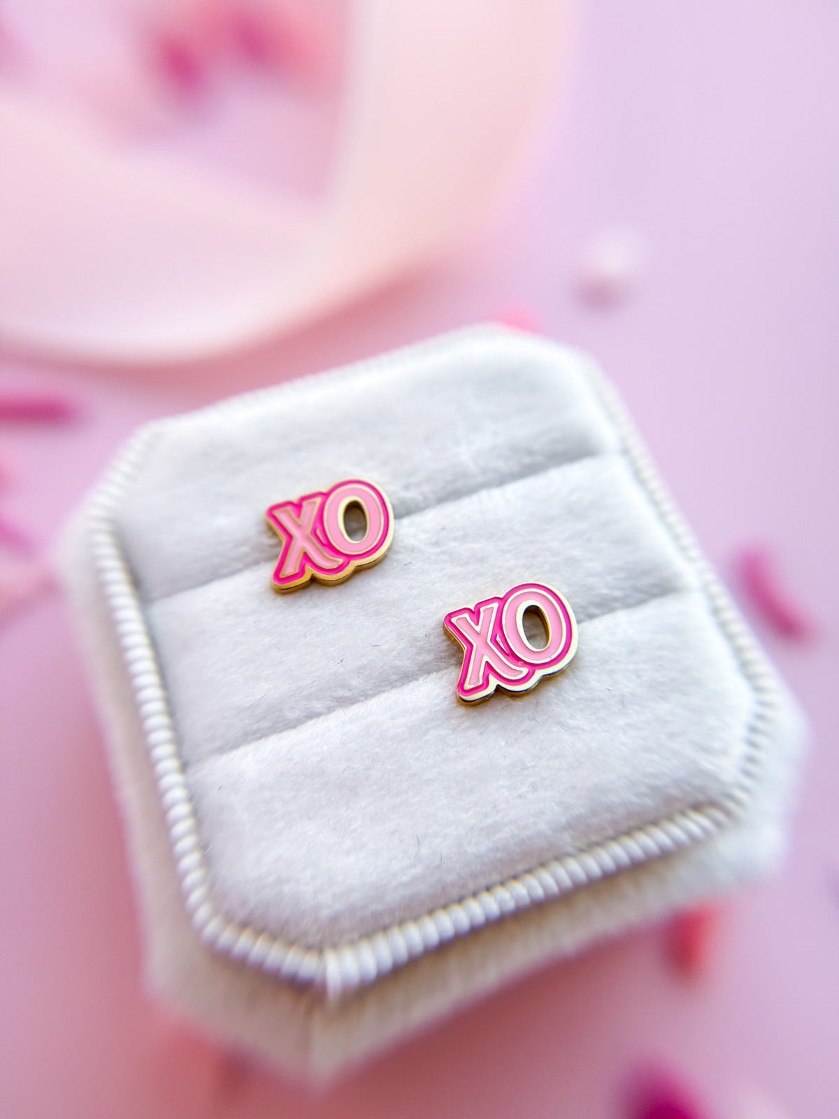 XOXO stud earrings close-up