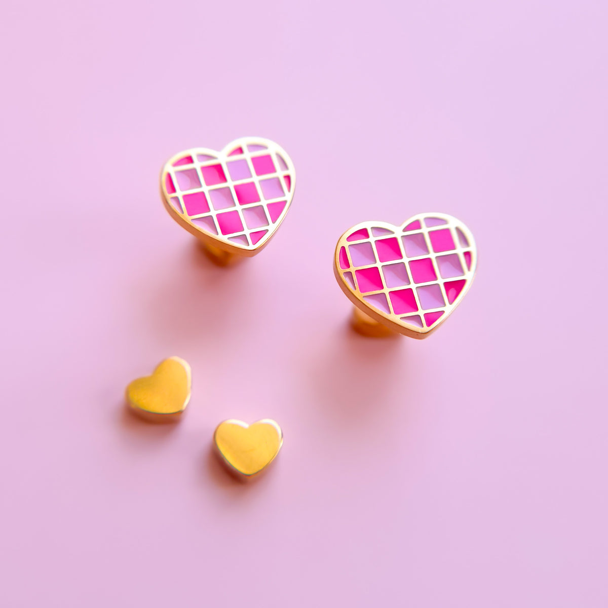 Pink checkered heart stud earrings close-up