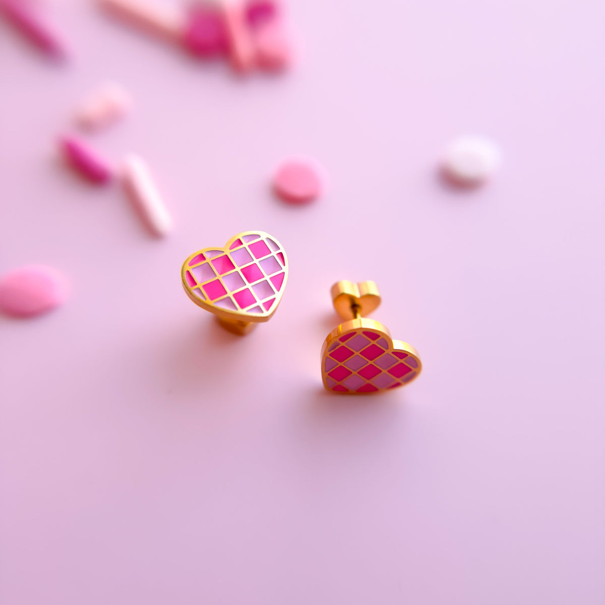 Pair of pink checkered heart stud earrings