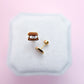 Smores stud earrings on white jewelry box with pink background 