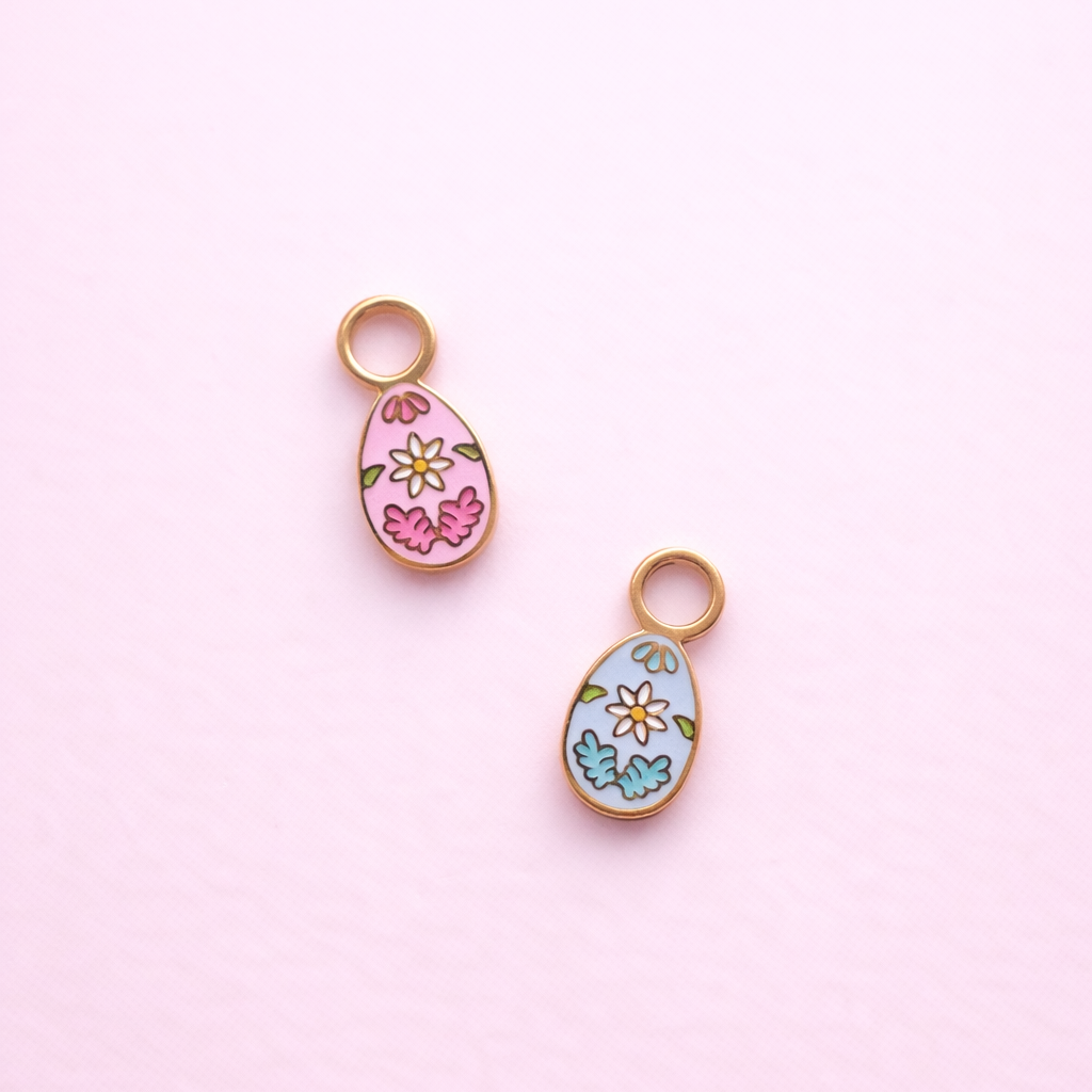 Floral egg charms 1 pink and 1 light blue on a light pink background