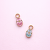 Floral egg charms 1 pink and 1 light blue on a light pink background