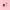 A pair of gold and black enamel earrings shaped like a book of spells, featuring a crescent moon and the word 'SPELLS', displayed on a solid pink background.