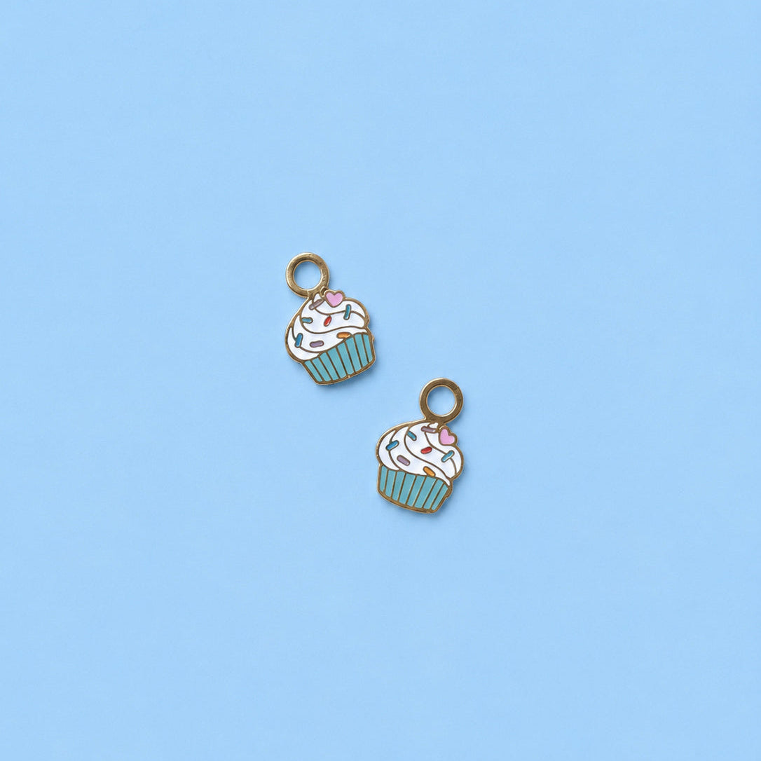 Two cupcake-shaped charms on a light blue background