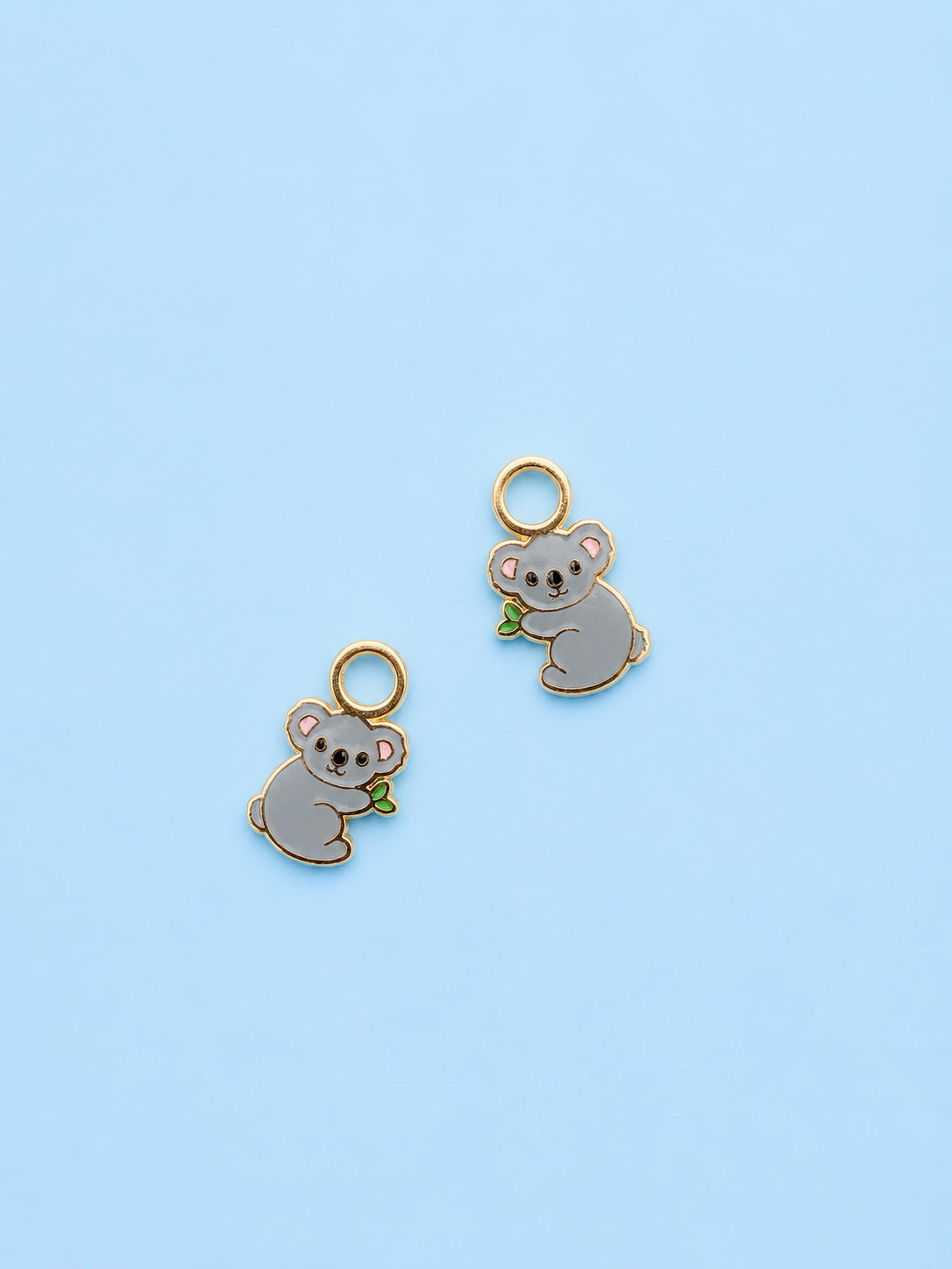 Koala huggie charms on blue background