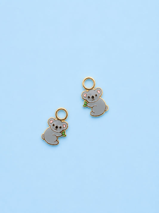 Koala huggie charms on blue background