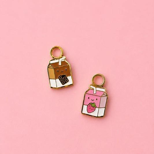 Two milk carton shaped huggie charms on a light pink background. One chocolate, one strawberry