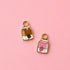 Two milk carton shaped huggie charms on a light pink background. One chocolate, one strawberry