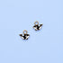 Two gold black and white orca whale-shaped charms on a light blue background