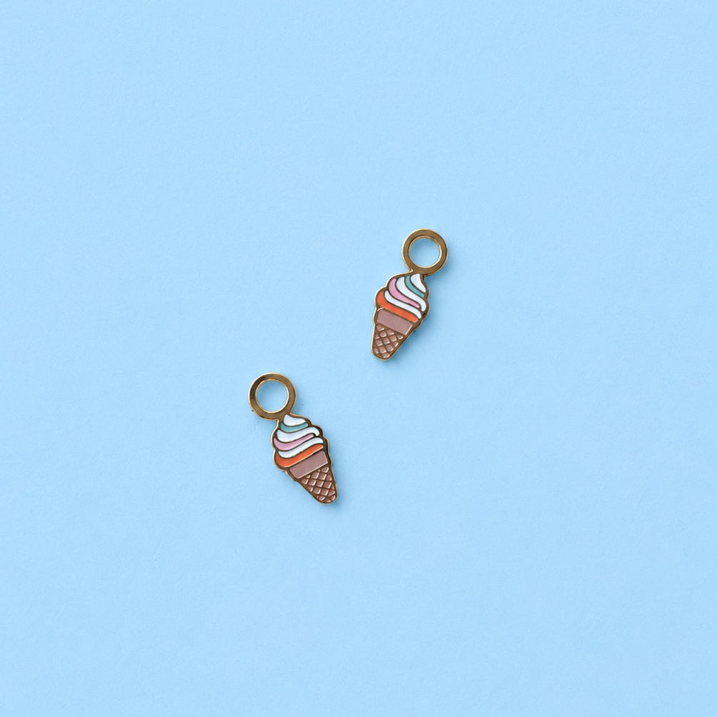Two ice cream cone charms on a light blue background