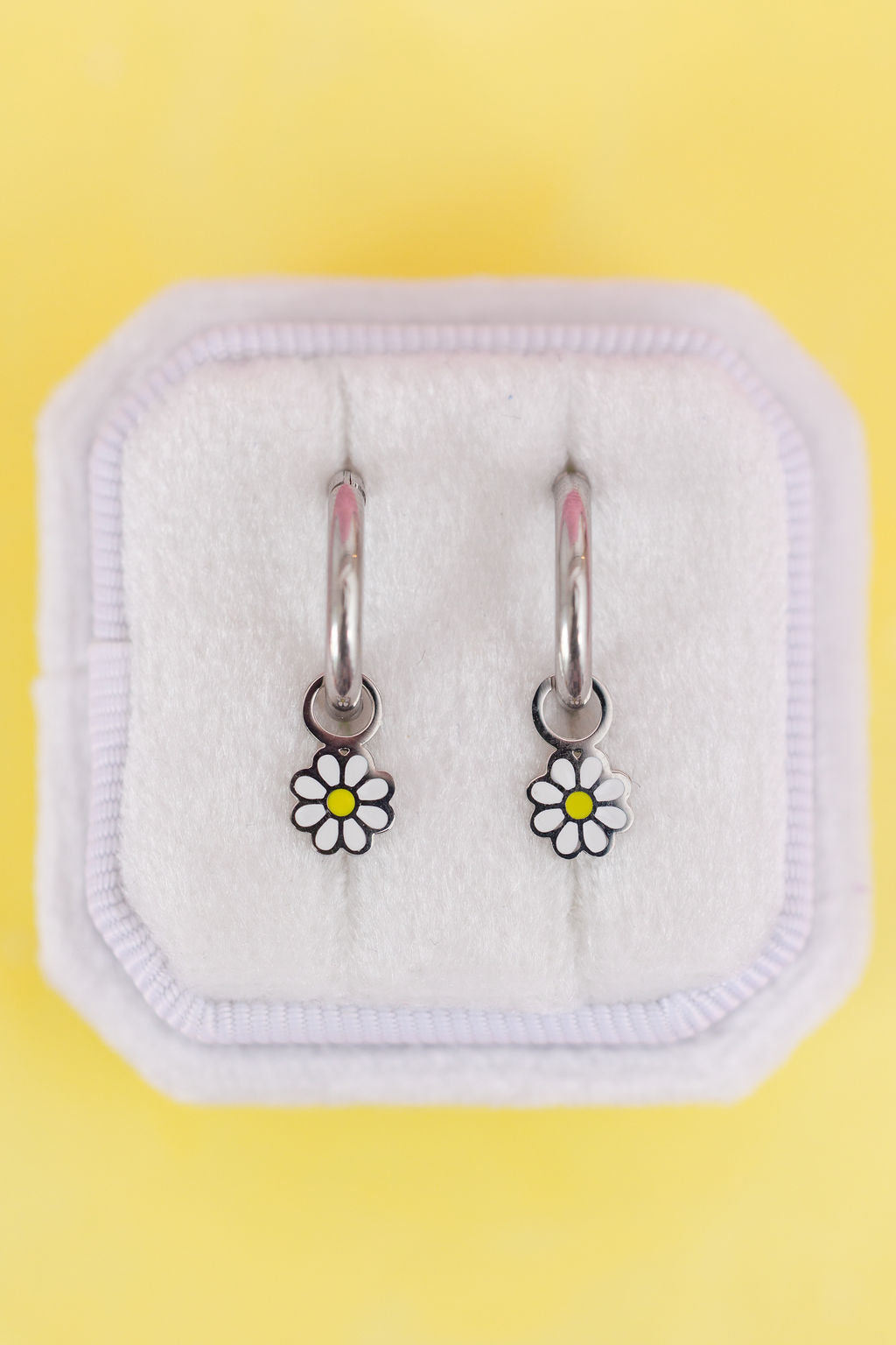 White daisy charms with silver huggie hoops
