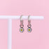 White daisy huggie charms on silver huggie hoops