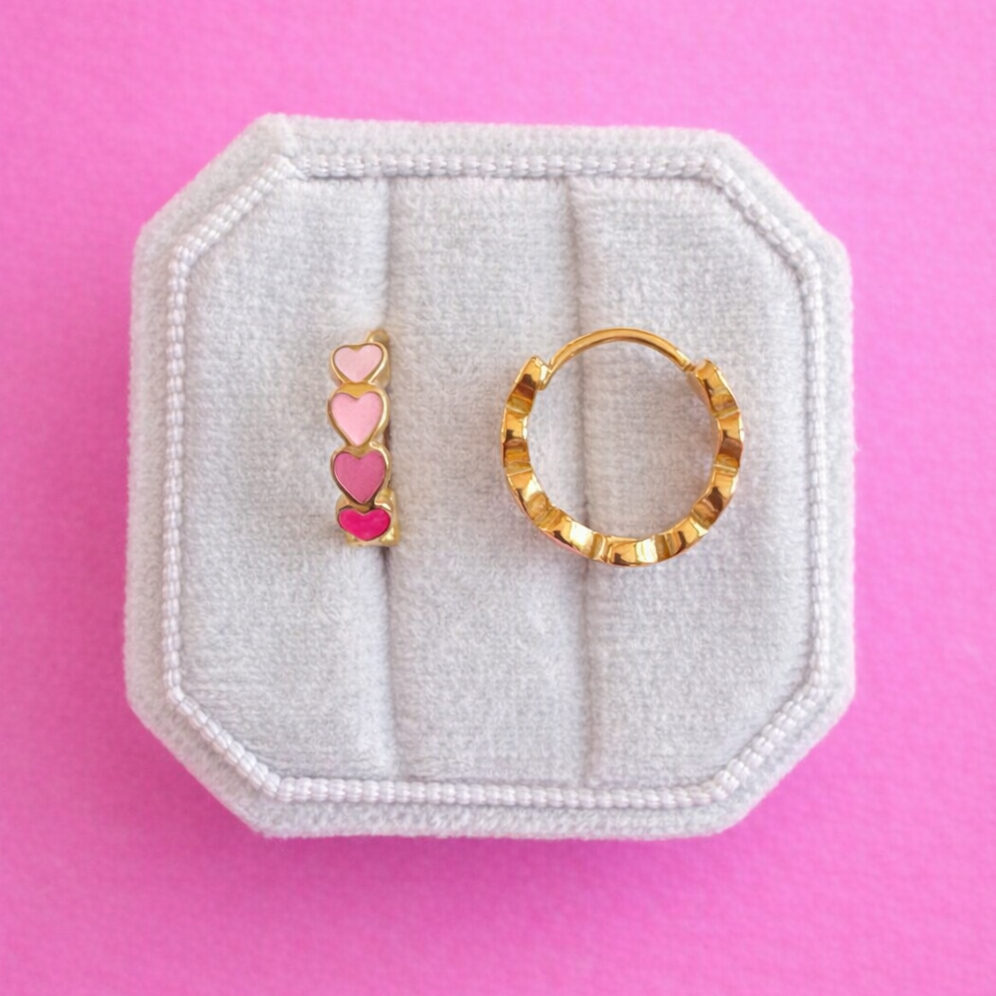pink heart huggie hoops on a pink background