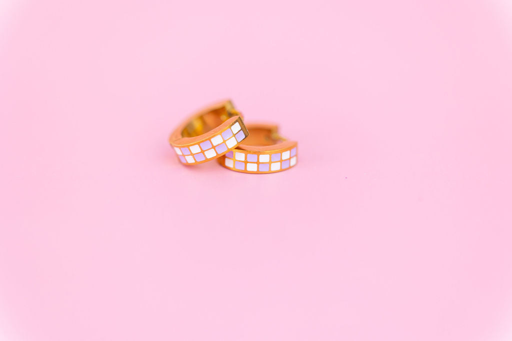 Lavender Checkered Chunky Huggie Hoops on a light pink background