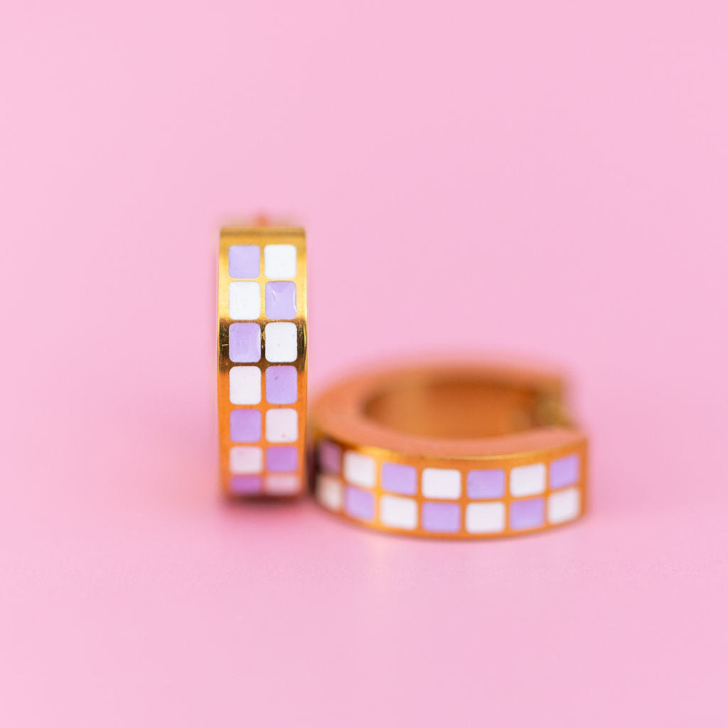 Lavender Checkered Chunky Huggie Hoops on a light pink background