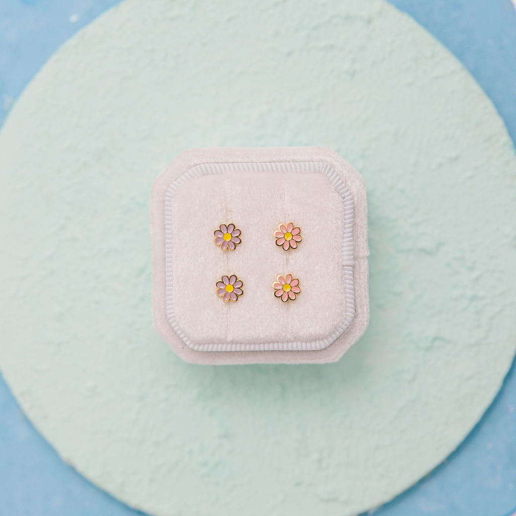 Close-up of lavender enamel daisy stud earrings