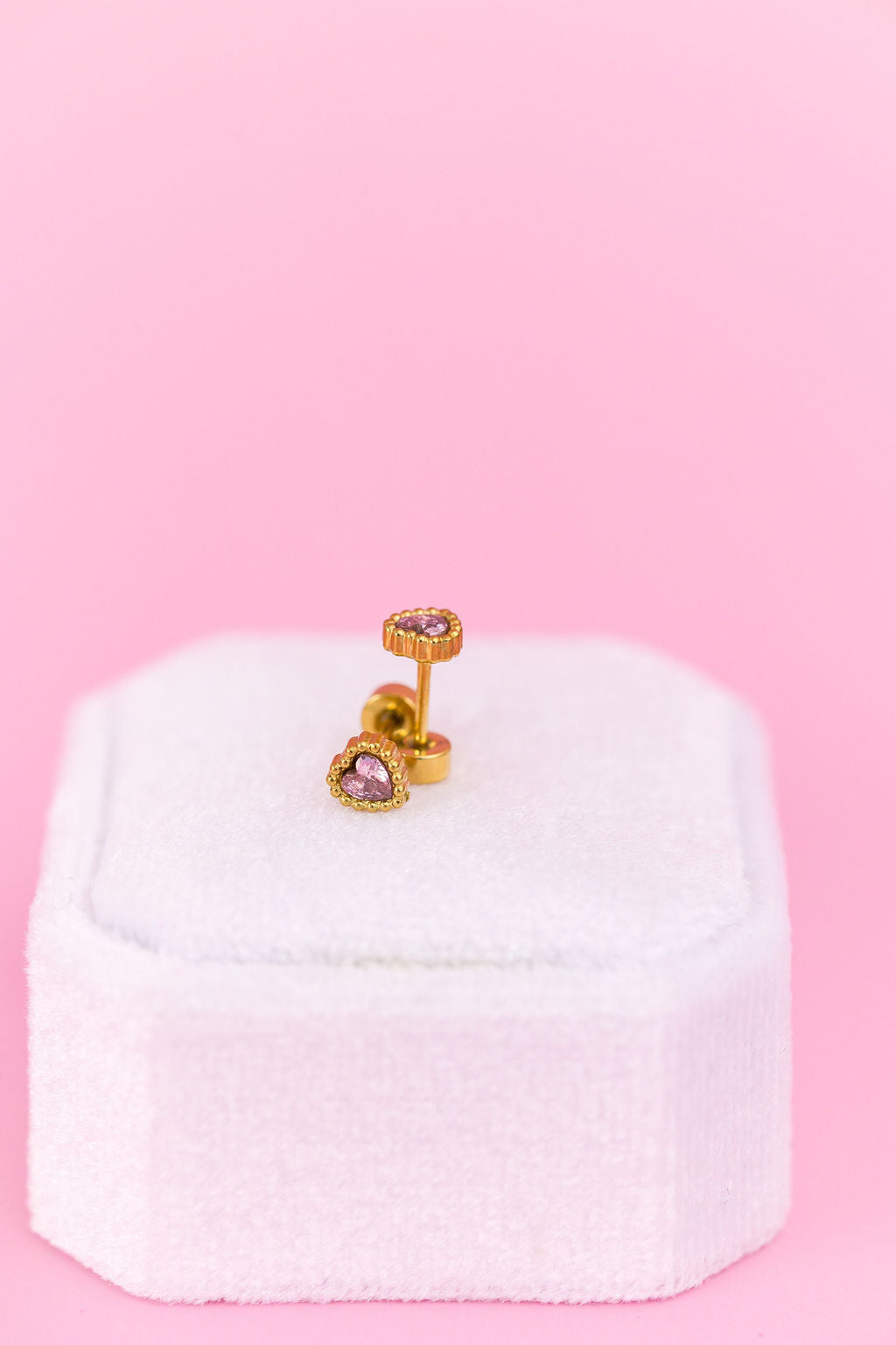 Pink heart gemstone stud earrings close-up