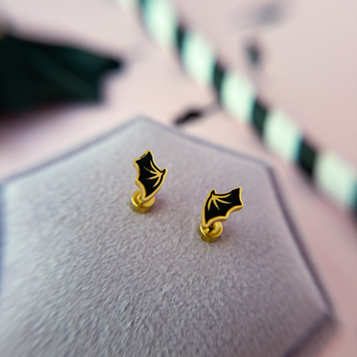 Bat wing stud earrings close-up