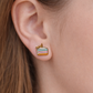 Birthday cake slice earring on young girl's ear