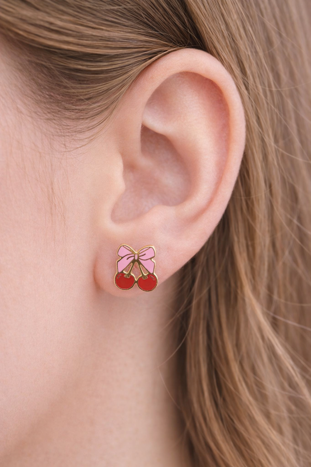 Bow Cherry Stud Earrings on a girl's ear
