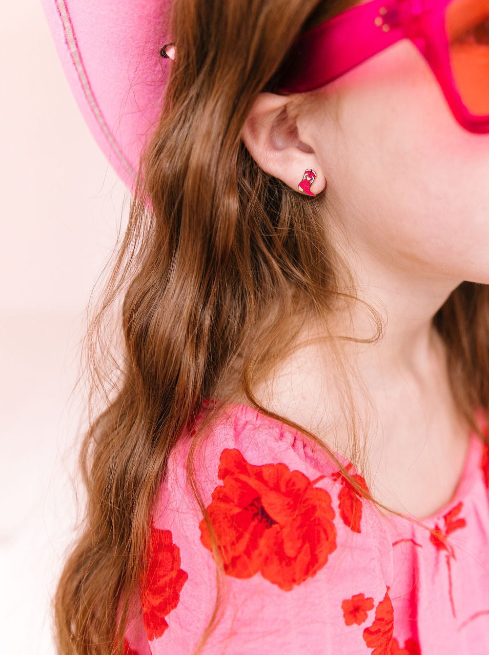 Cowboy boot stud earring worn on an ear
