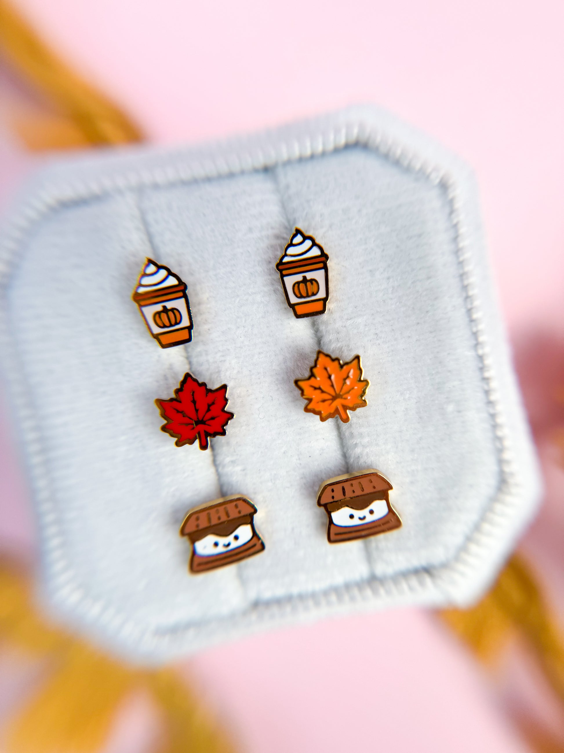 Set of autumn-themed earrings on a white square background