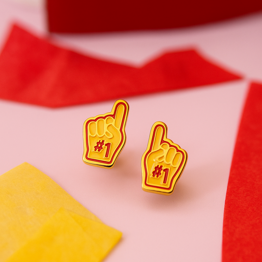 Yellow and red foam finger earrings on a pink and red background