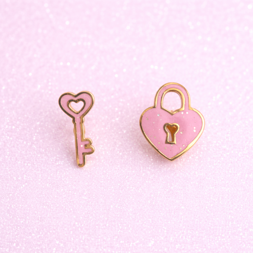 Pink heart lock and key earring set on glittery pink background
