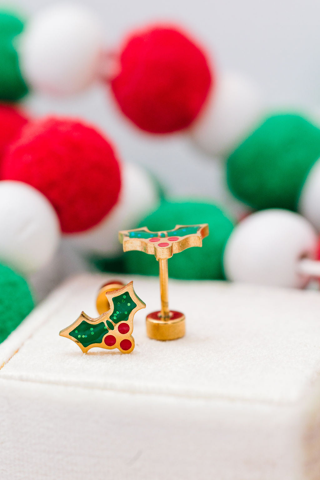 Holiday holly stud earrings close-up