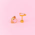 Hot Cocoa Stud Earrings against a light pink background