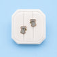Koala stud earrings on a white jewelry box on a blue background
