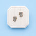 Koala stud earrings on a white jewelry box on a blue background