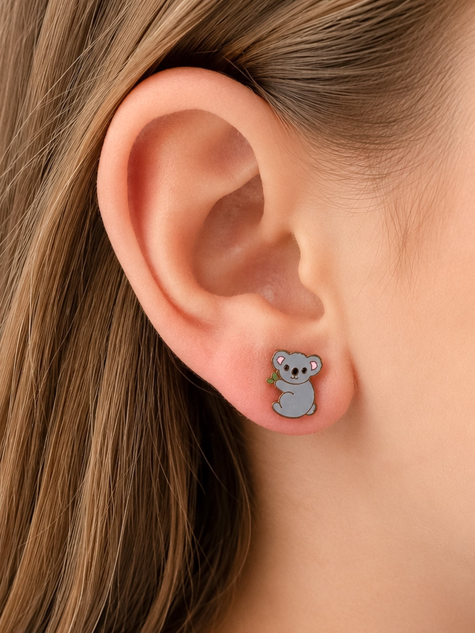Koala studs on a girl's ear 