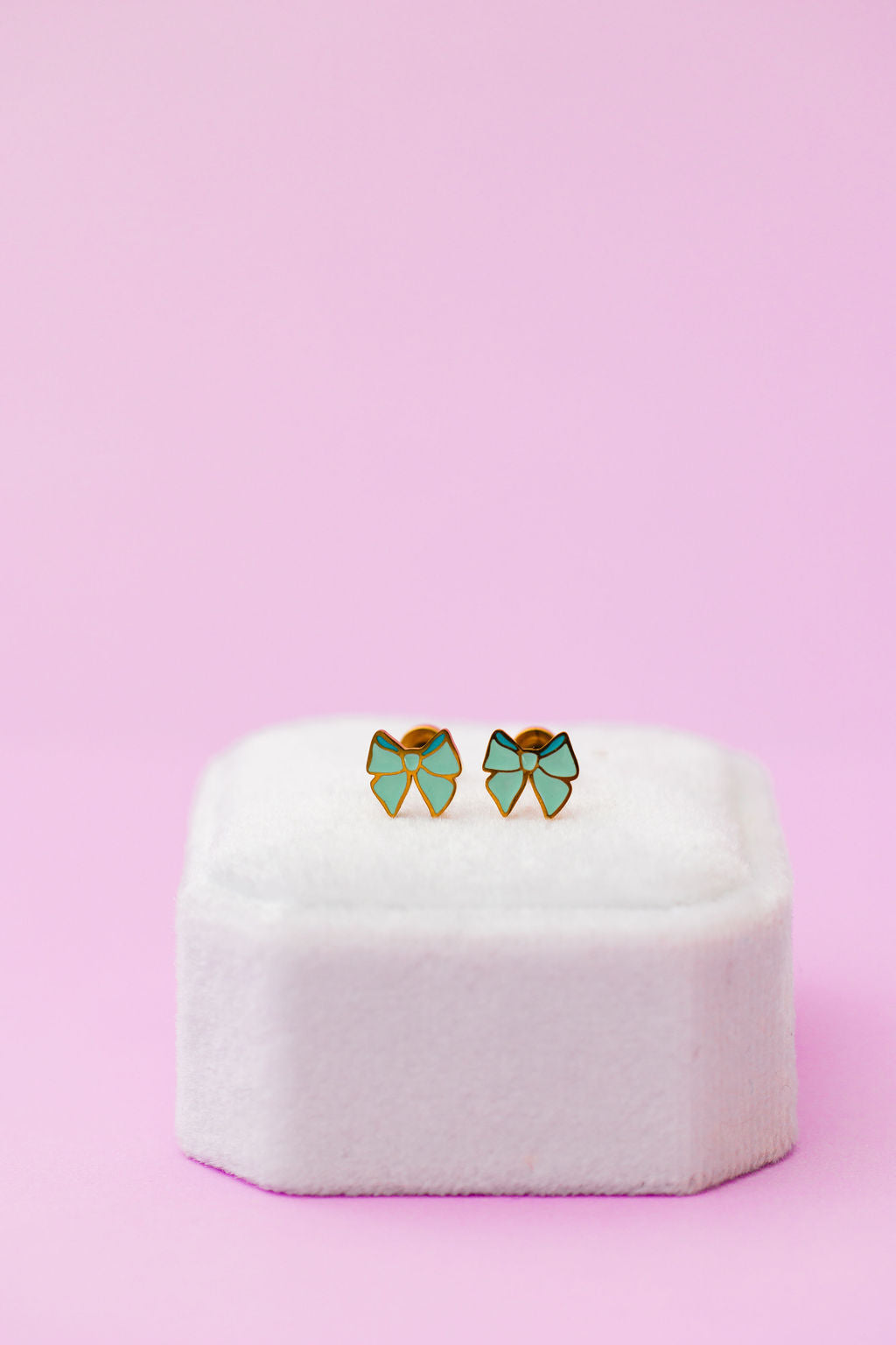 Mint bow stud earrings, front view
