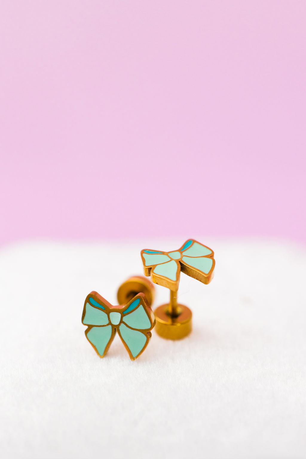Mint bow stud earrings close-up