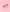 A pair of gold butterfly-shaped stud earrings with black enamel detailing, displayed on a solid pink background.