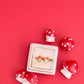 Red mushroom-shaped earrings with a white box on a red background