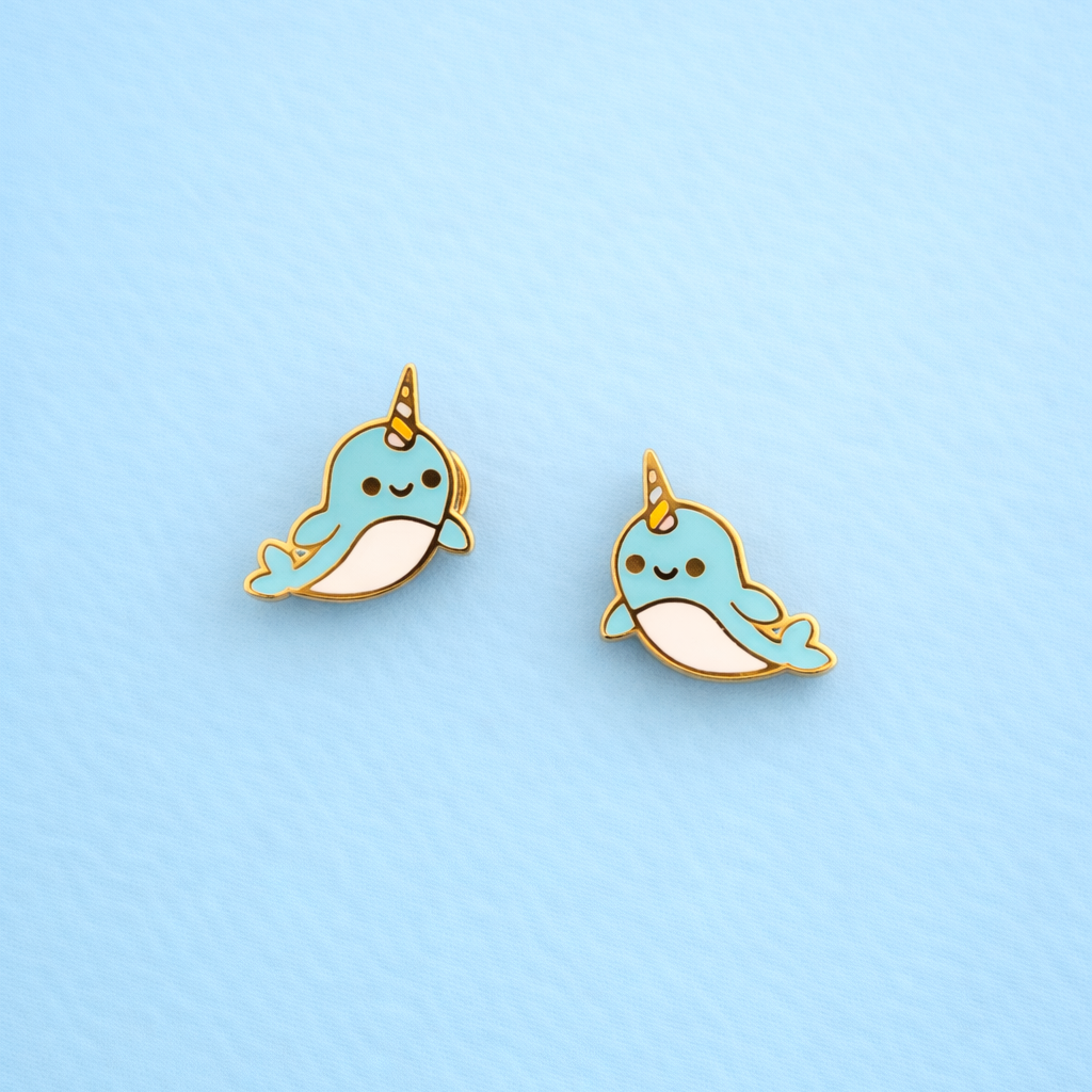 Narwhal earrings on blue background