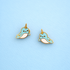 Narwhal earrings on a light blue background