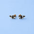 Pair of orca whale earrings on a light blue background