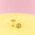 Peace Sign Stud Earrings against a light yellow and light pink background