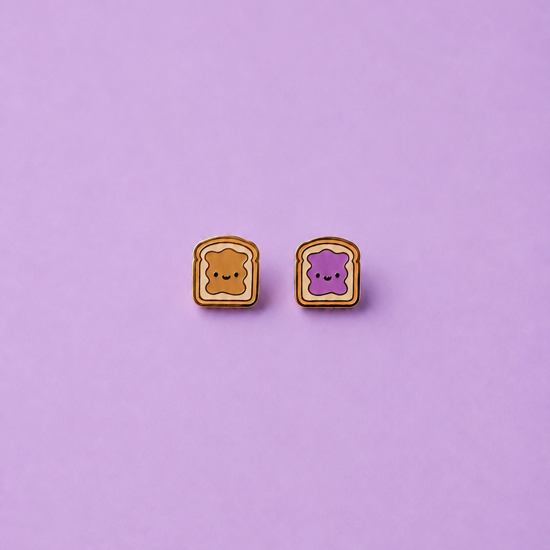 Peanut butter and jelly shaped enamel stud earrings on a light purple background