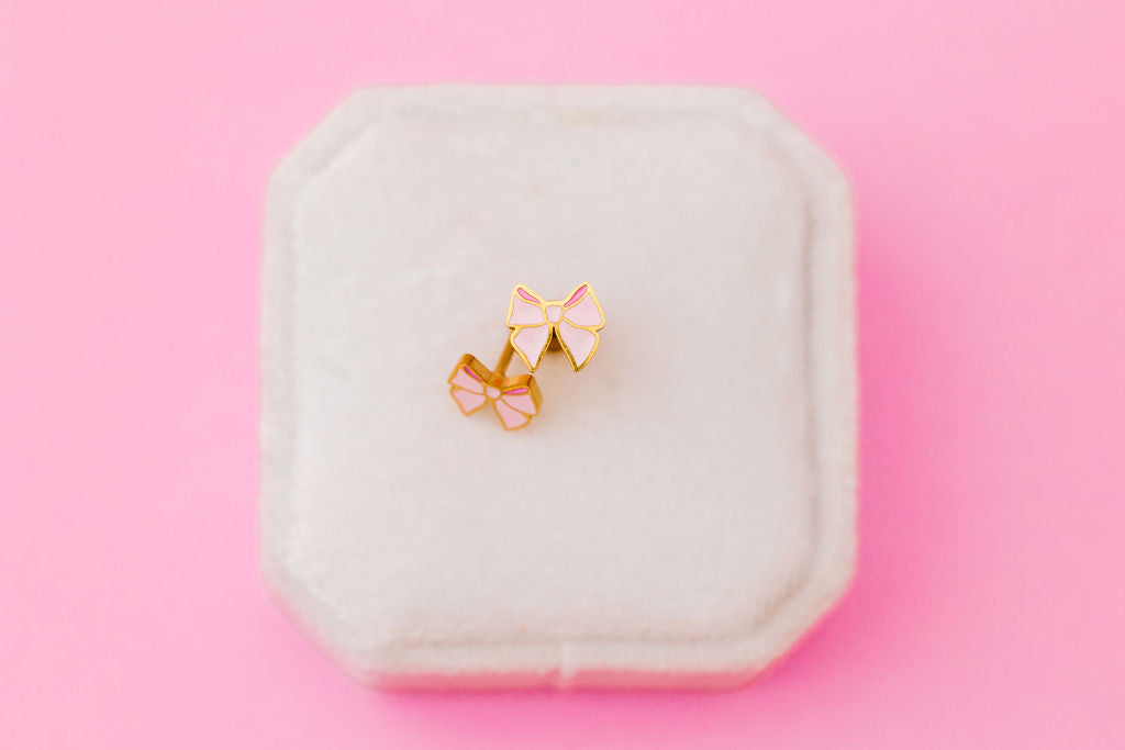 Pink bow stud earrings, front view