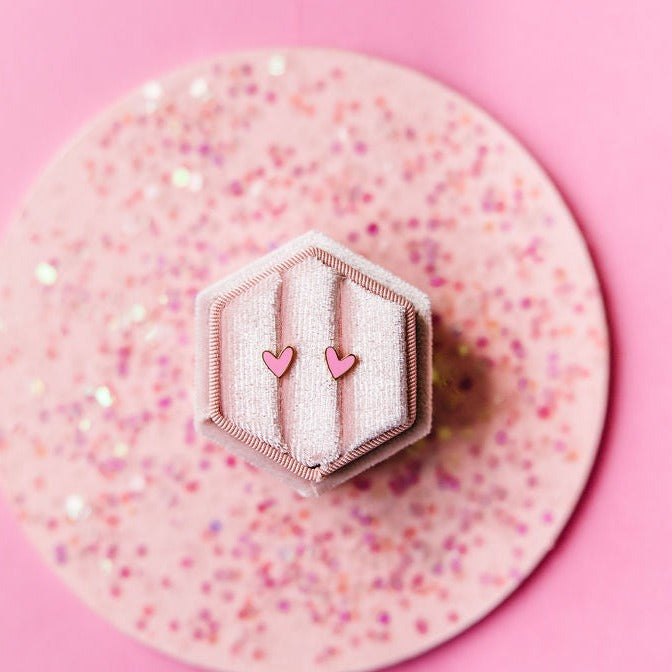 Pink heart stud earrings close-up