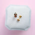Pumpkin Spice Latte shaped flat back earrings on a white jewelry box with a pink background