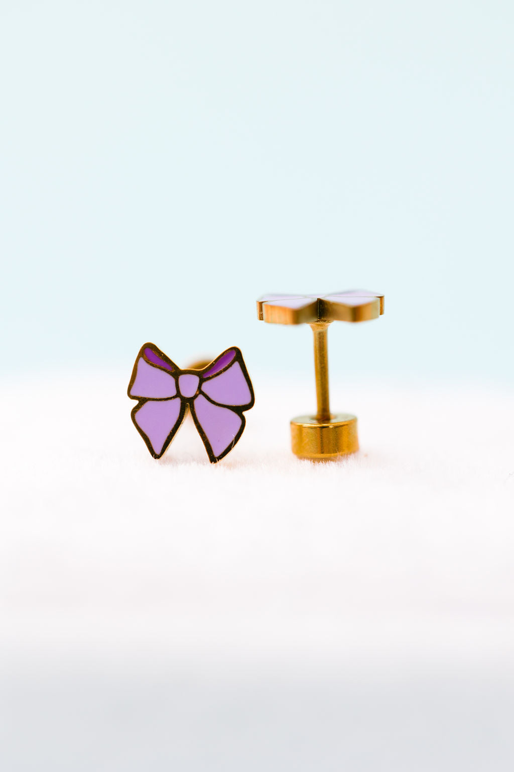 Lavender bow stud earrings close-up