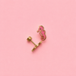 Pink seahorse earring on a pink background